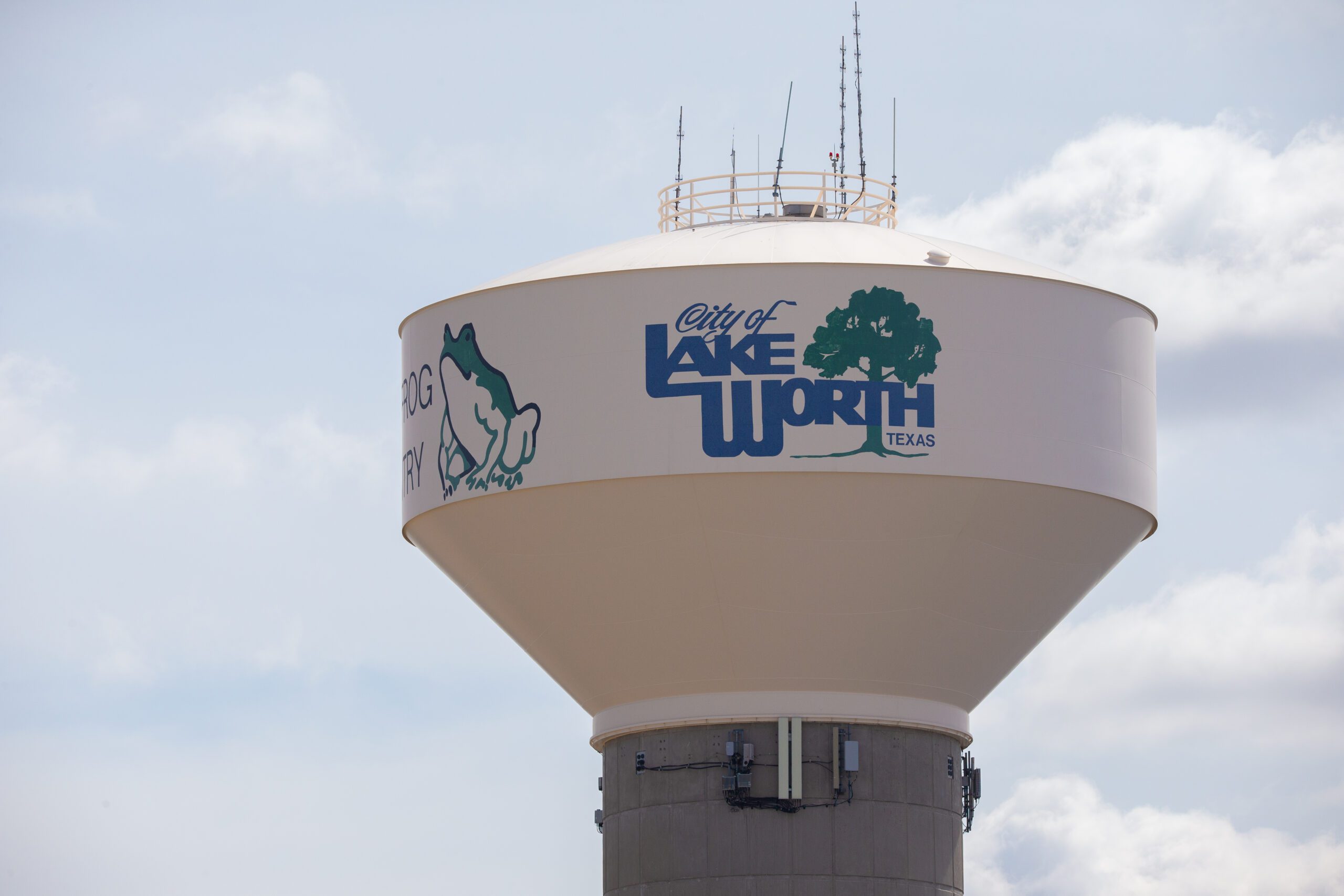 A worker from The Mop & Broom cleans a kitchen sink in Burleson, showcasing their professional cleaning services.