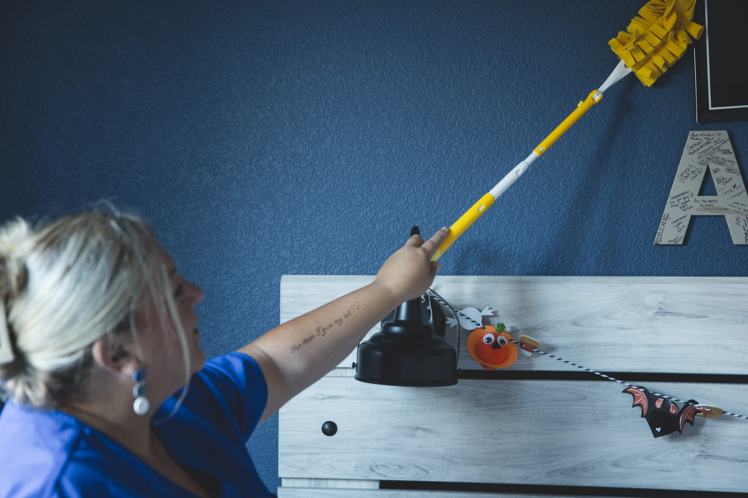 House cleaning service near me by The Mop & Broom in Flower Mound, TX, featuring a cleaner spraying disinfectant on a countertop.