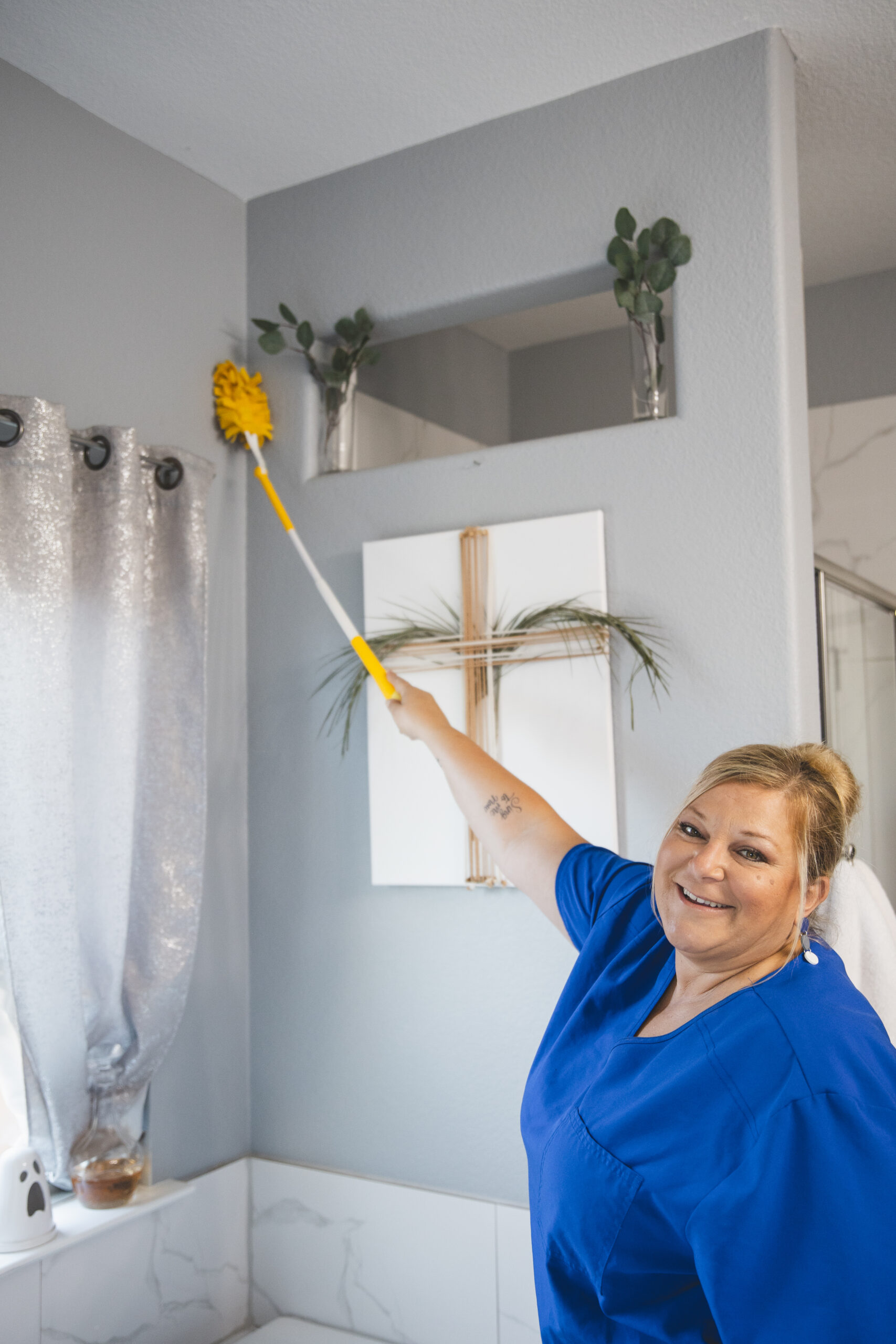 Professional cleaner in White Settlement using a duster for thorough cleaning by The Mop & Broom