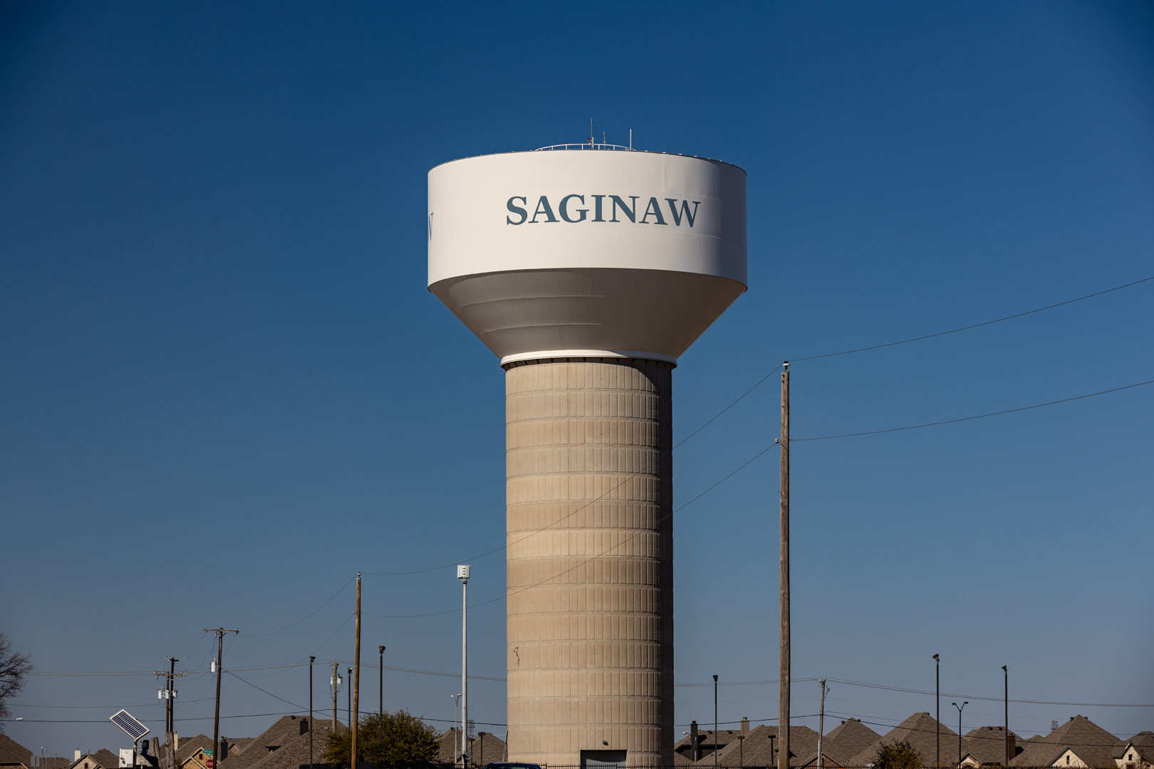 A worker from The Mop & Broom cleans a kitchen sink in Burleson, showcasing their professional cleaning services.